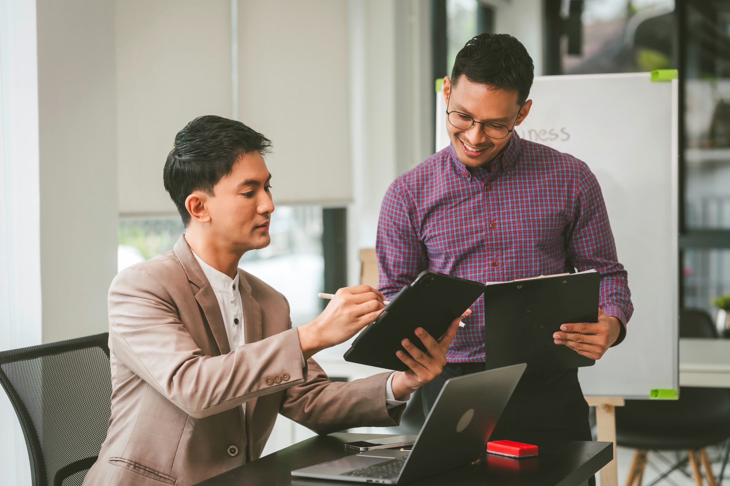 Two men discussing business at an office.
