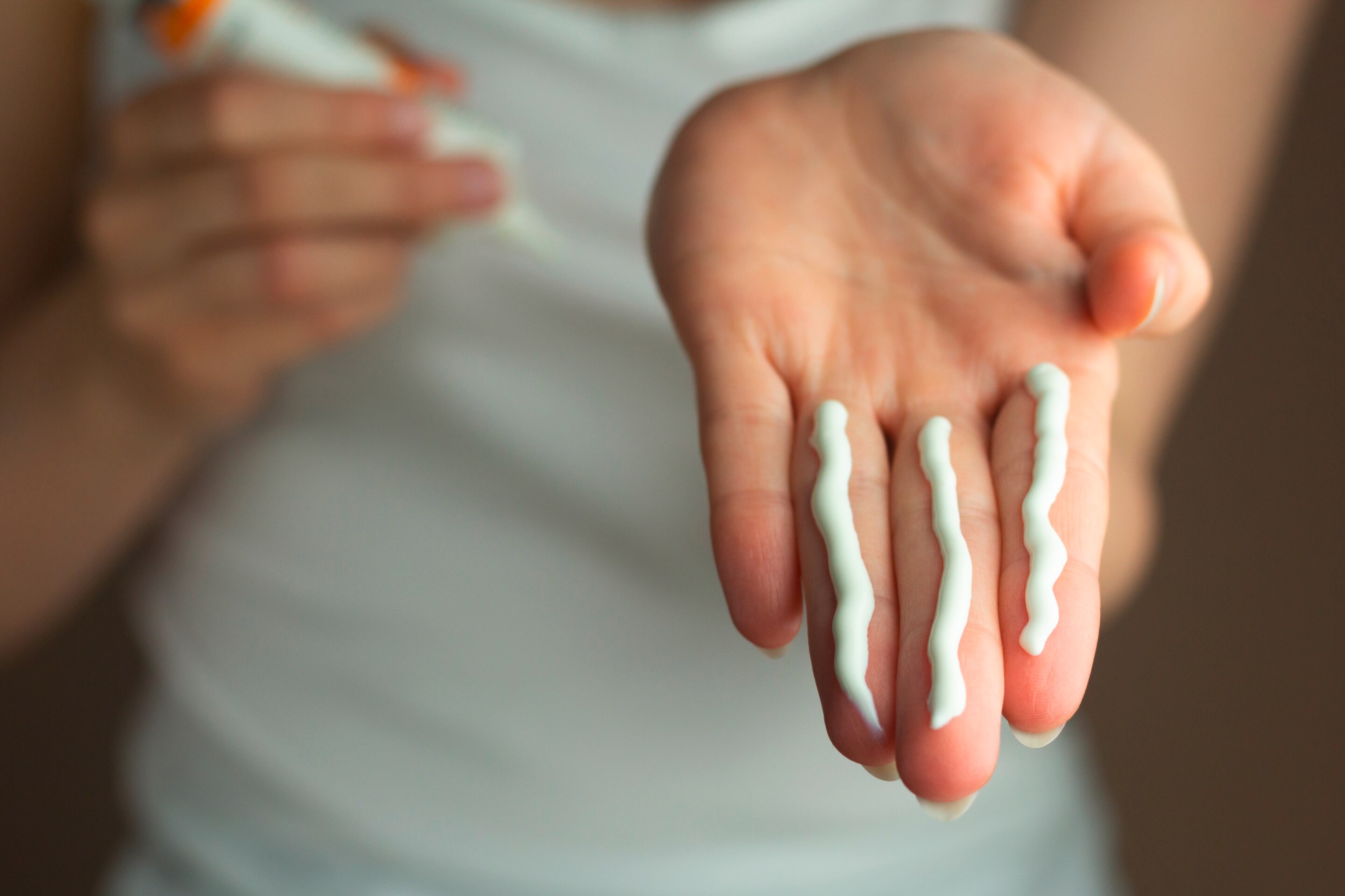 Person showing correct amount of sunscreen to apply.
