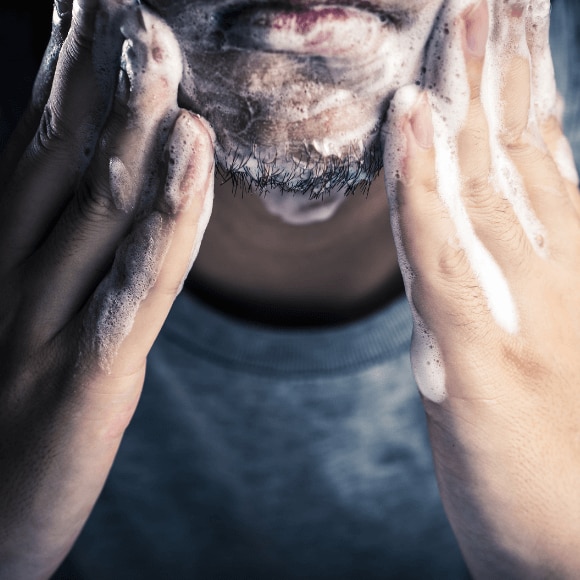 Man washing his face