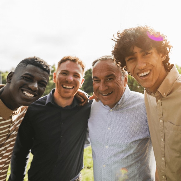 Group of multi-generational men looking confident and happy because they’re wearing the best deodorant for their needs.