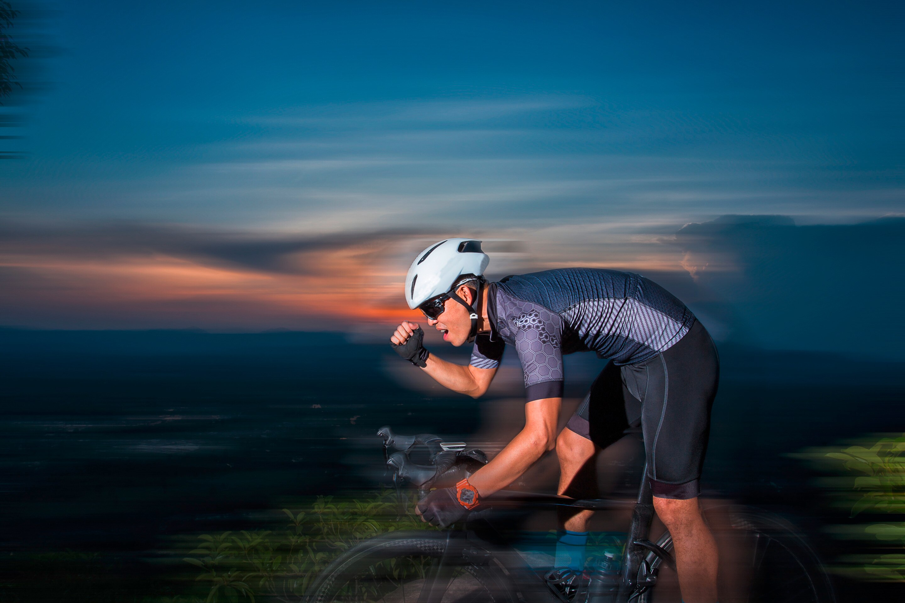 Man mountain biking at night.
