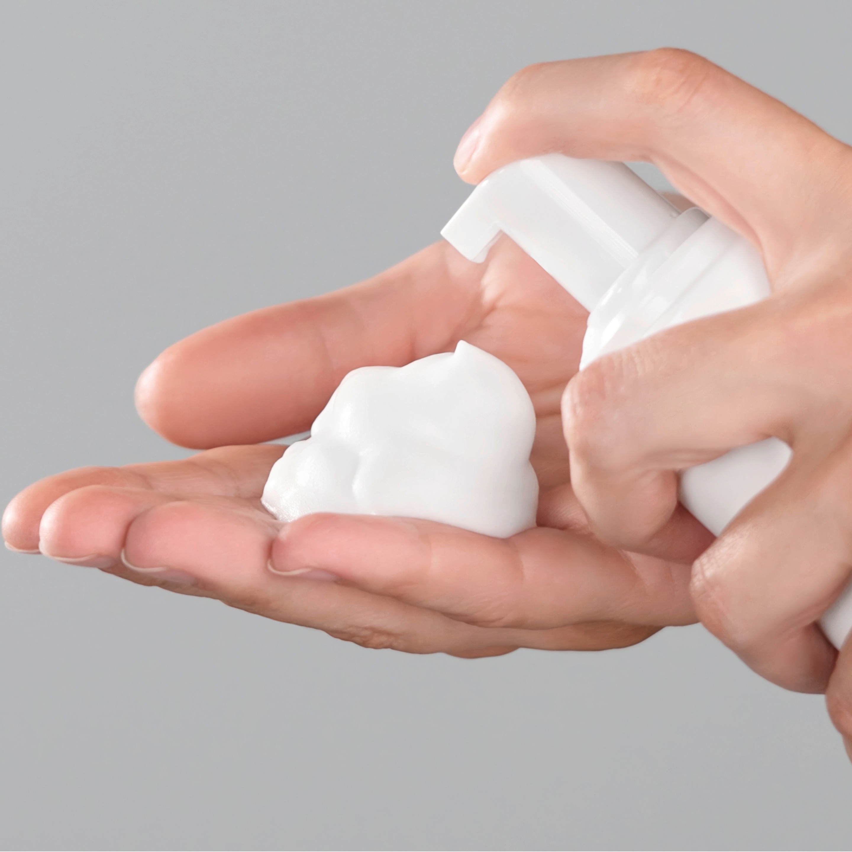 Hair mousse sprayed on hand.