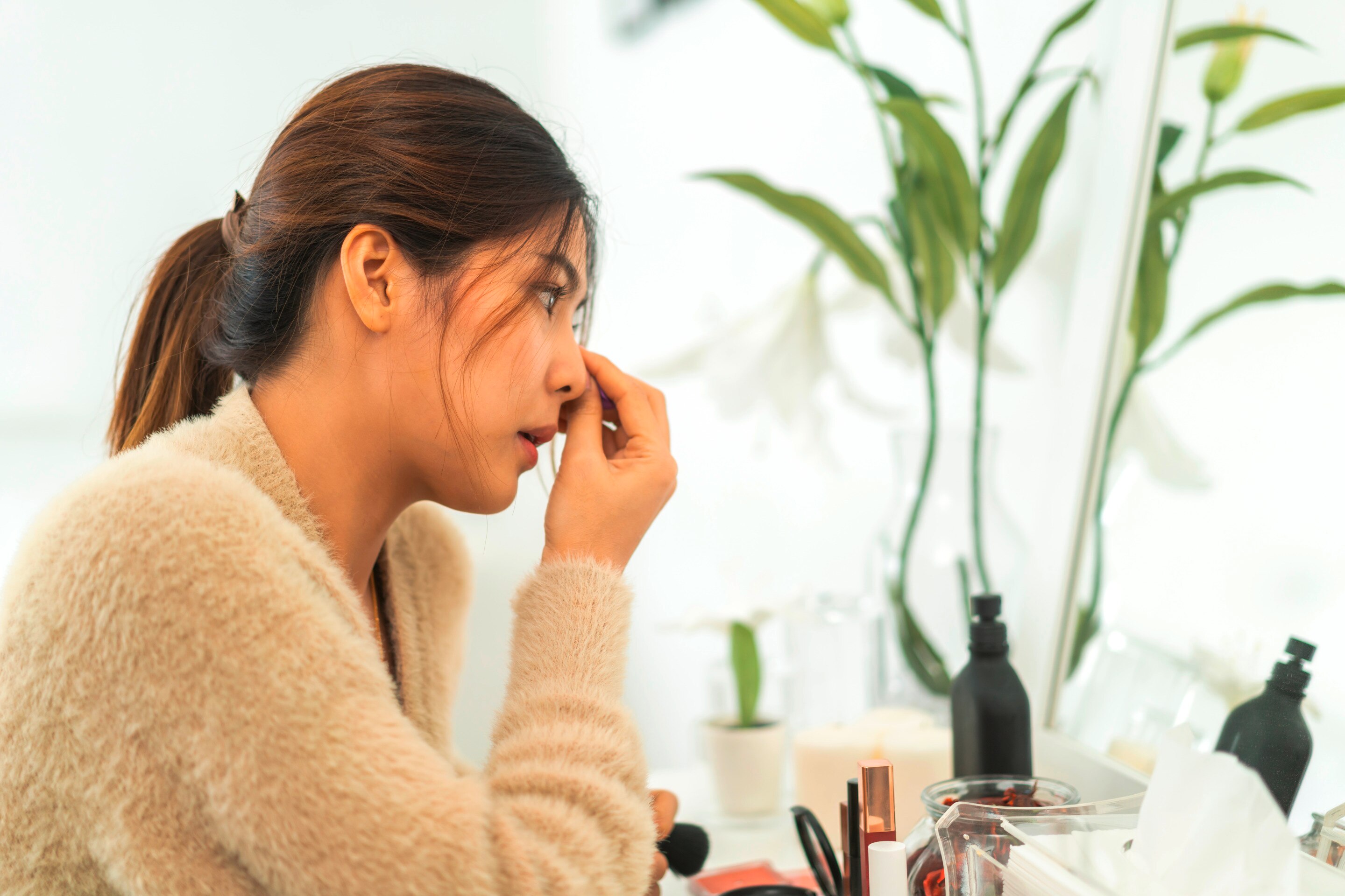 Woman blending her foundation with a beauty sponge.