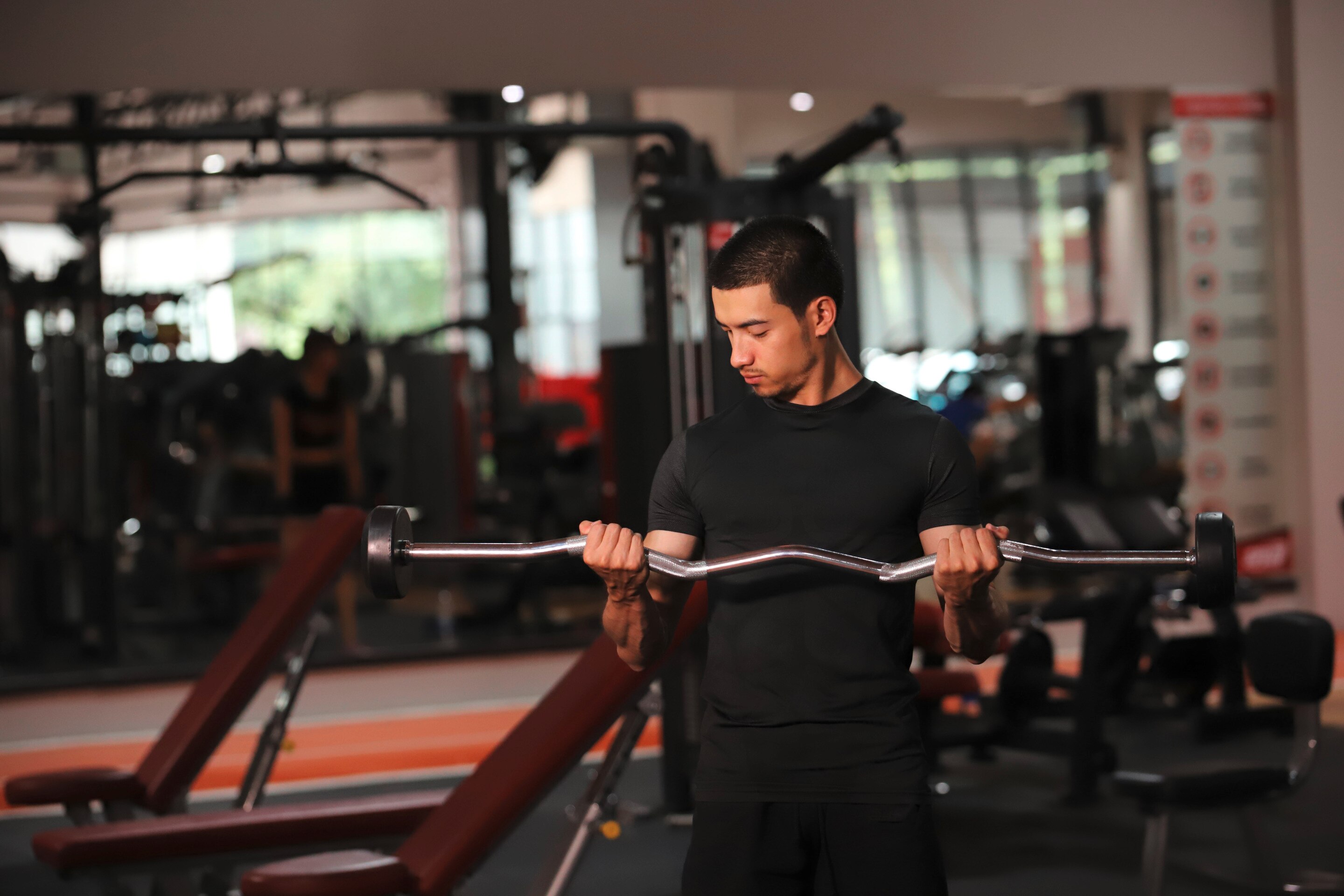 Man lifting weights at gym.