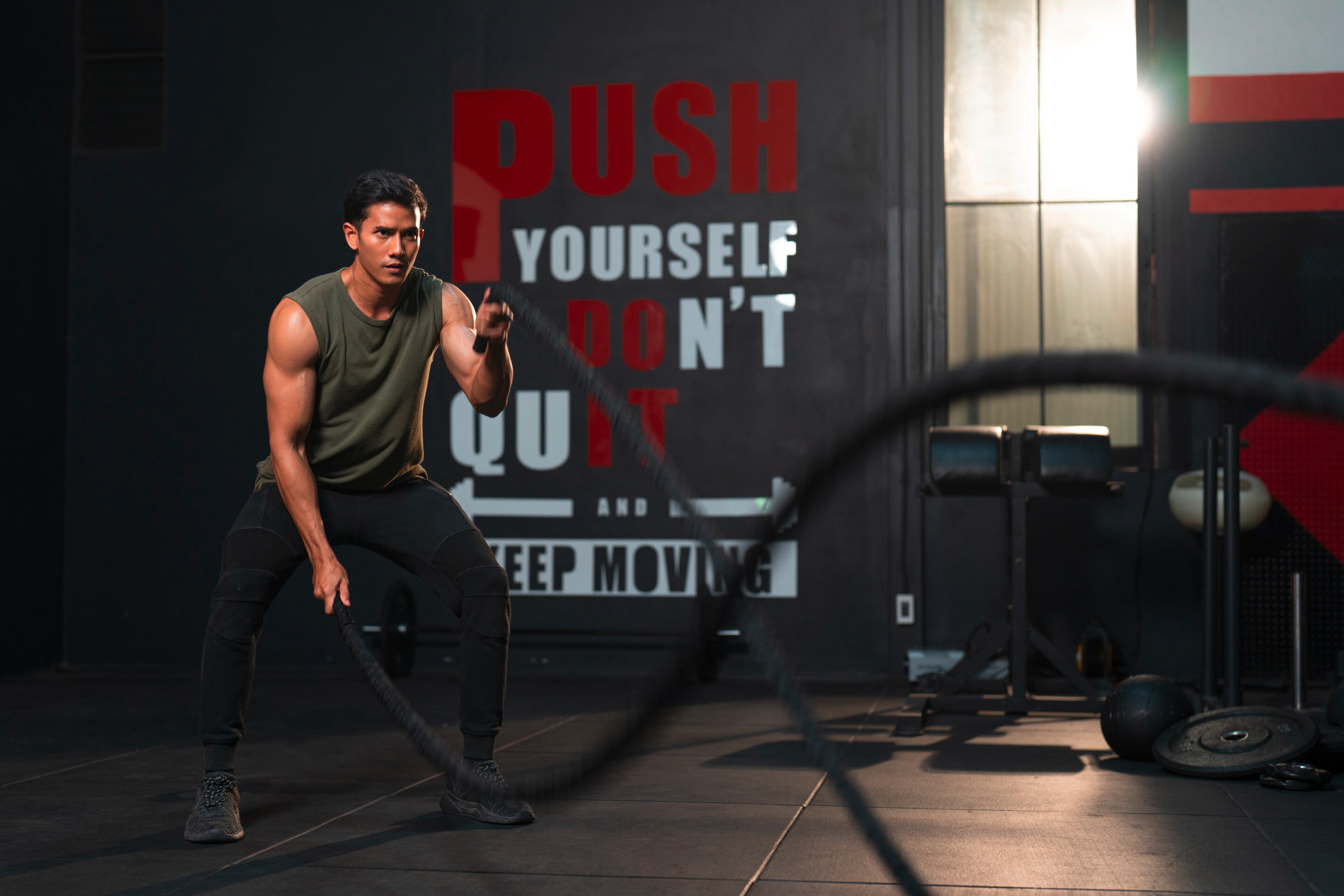 Man working out with battle ropes.