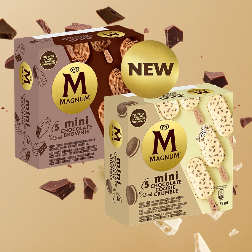 A box of Magnum Mini Cookie Crumble and Chocolate Brownie surrounded by pieces of white and brown chocolate.