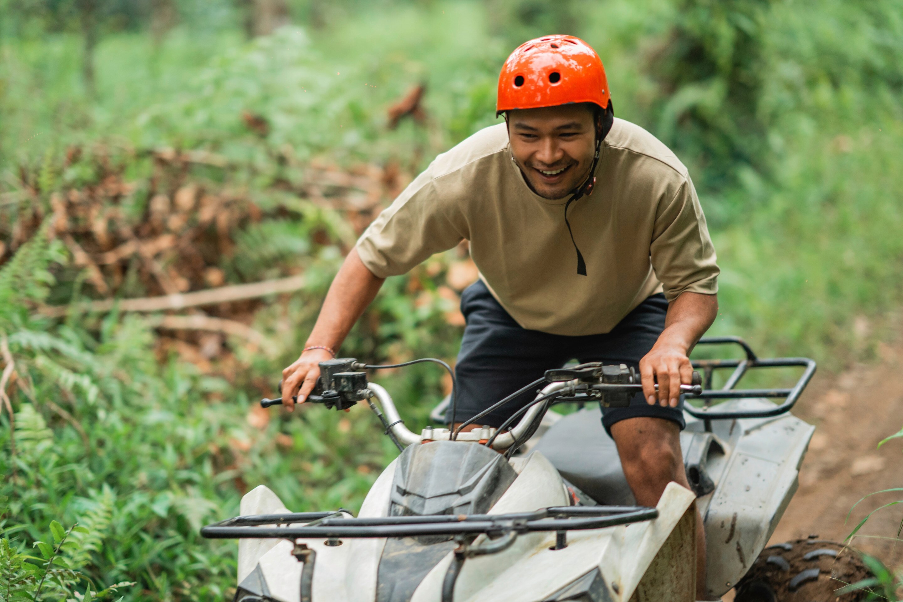 Man riding an ATV with excitement.