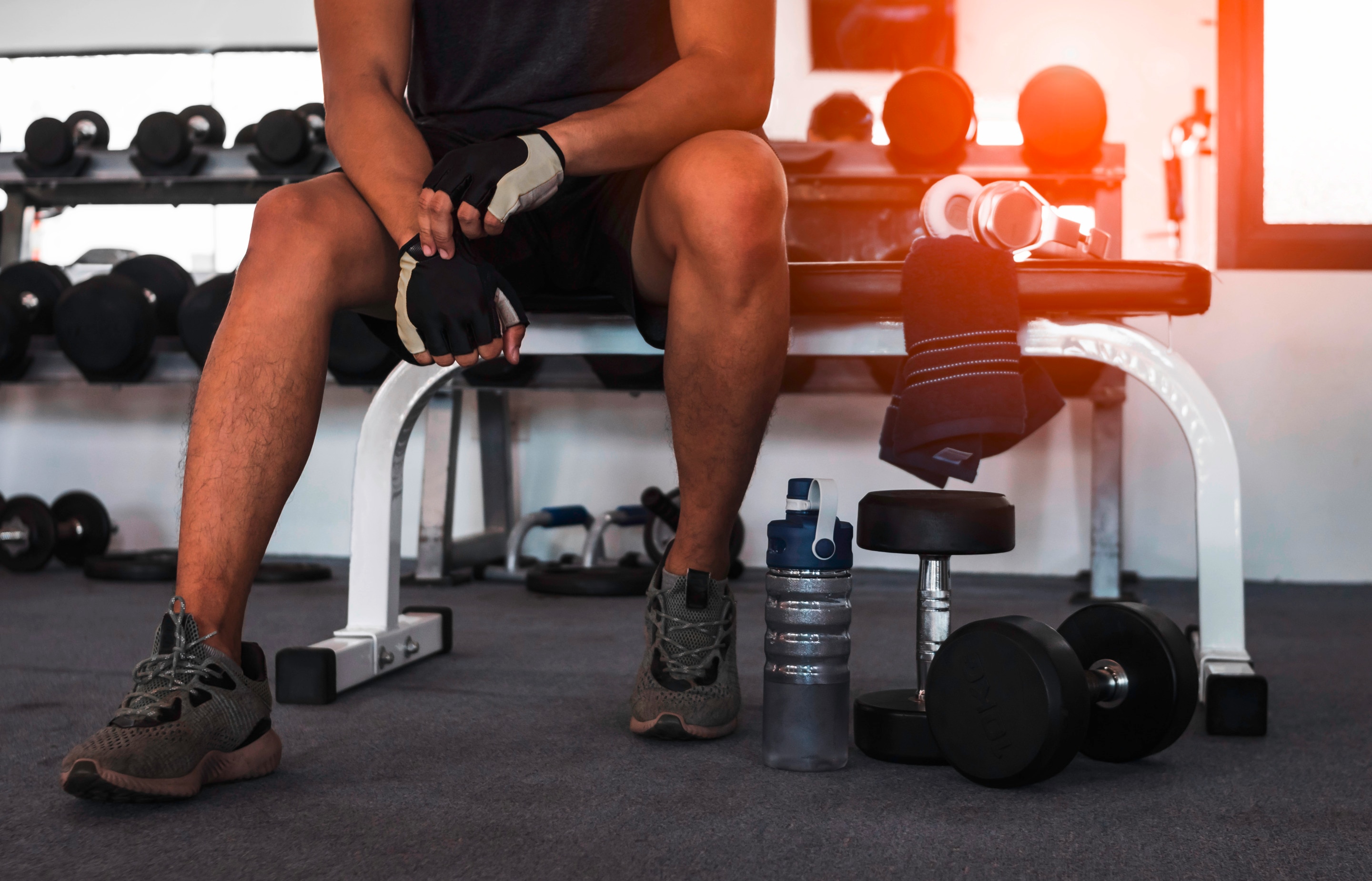 Man wearing lifting gloves.
