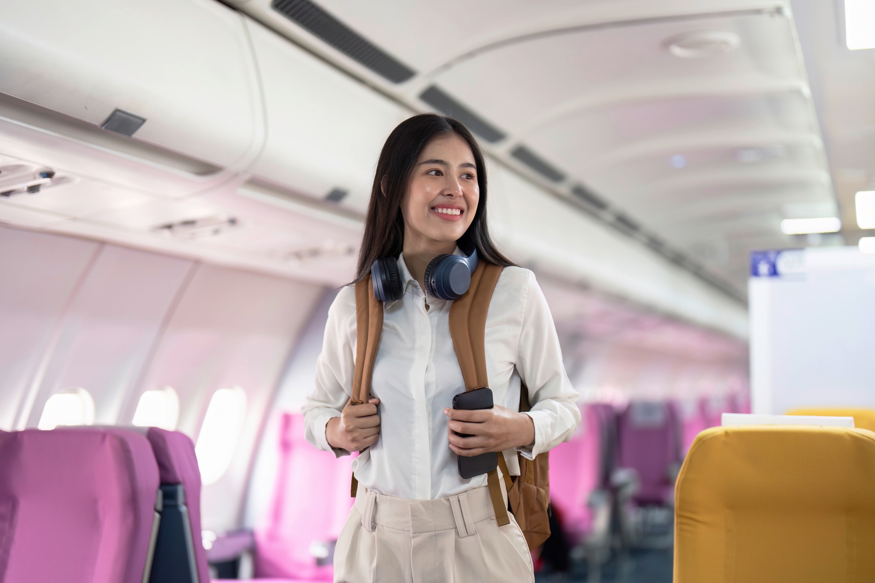 Asian woman boarding plane.