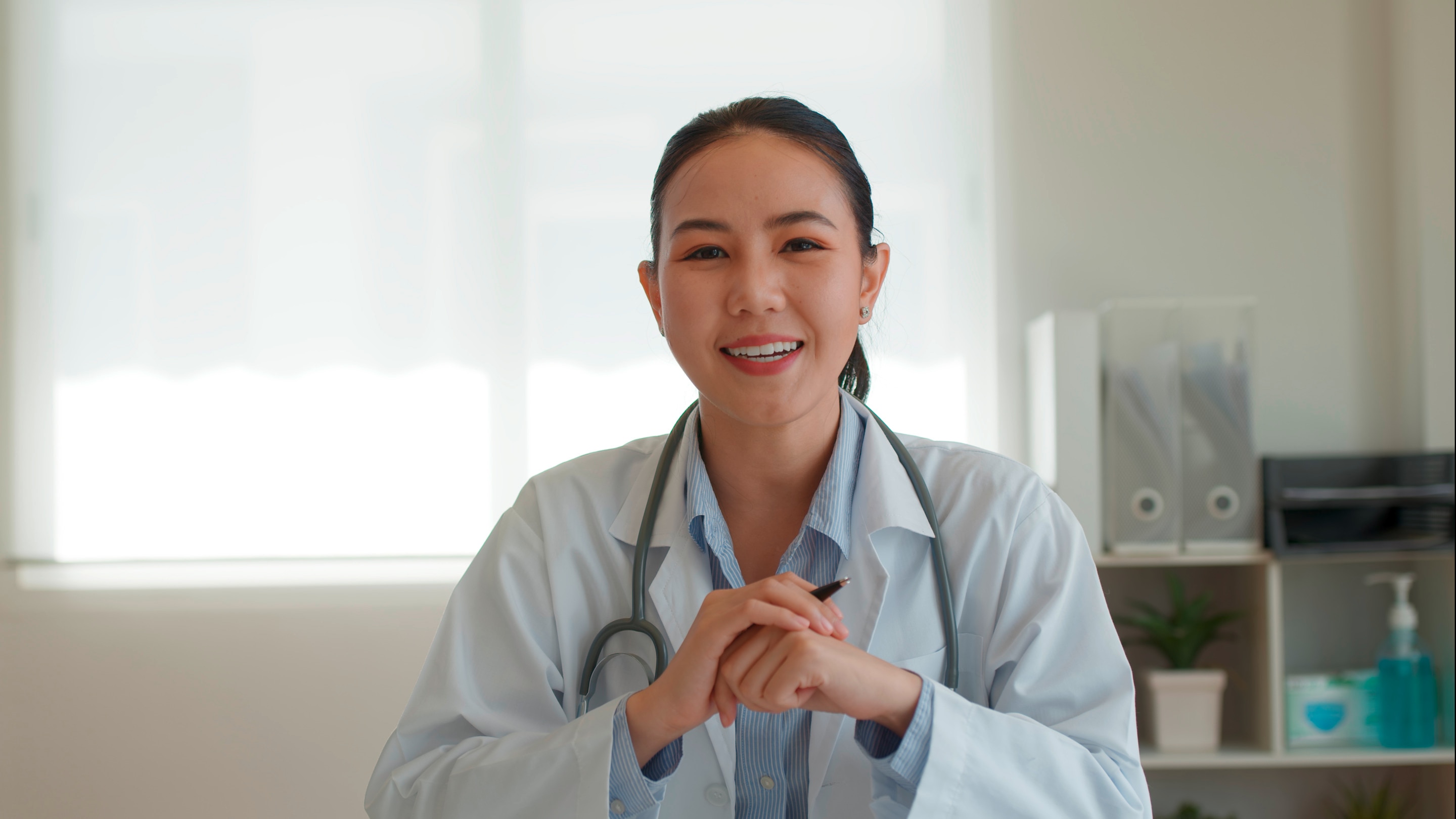 Asian doctor smiling.