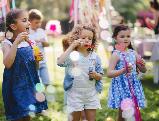 Kids at a birthday party blowing bubbles