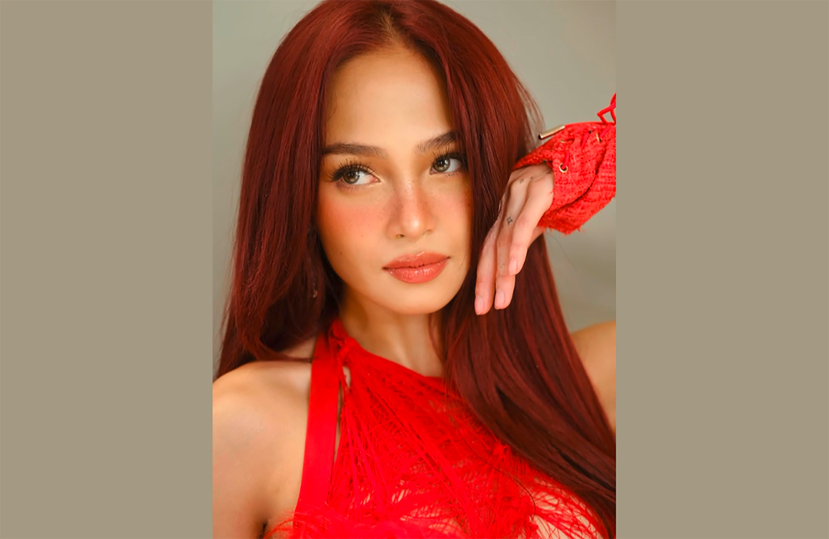 Filipina actress and dancer with red hair.