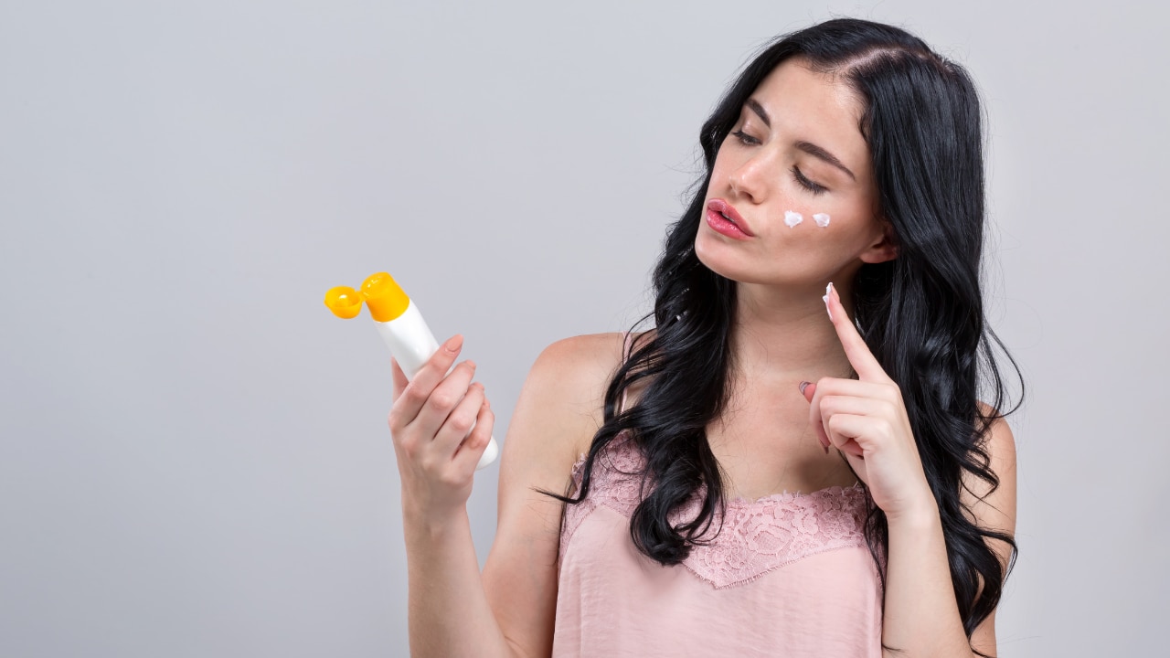 A girl applying Sunscreen