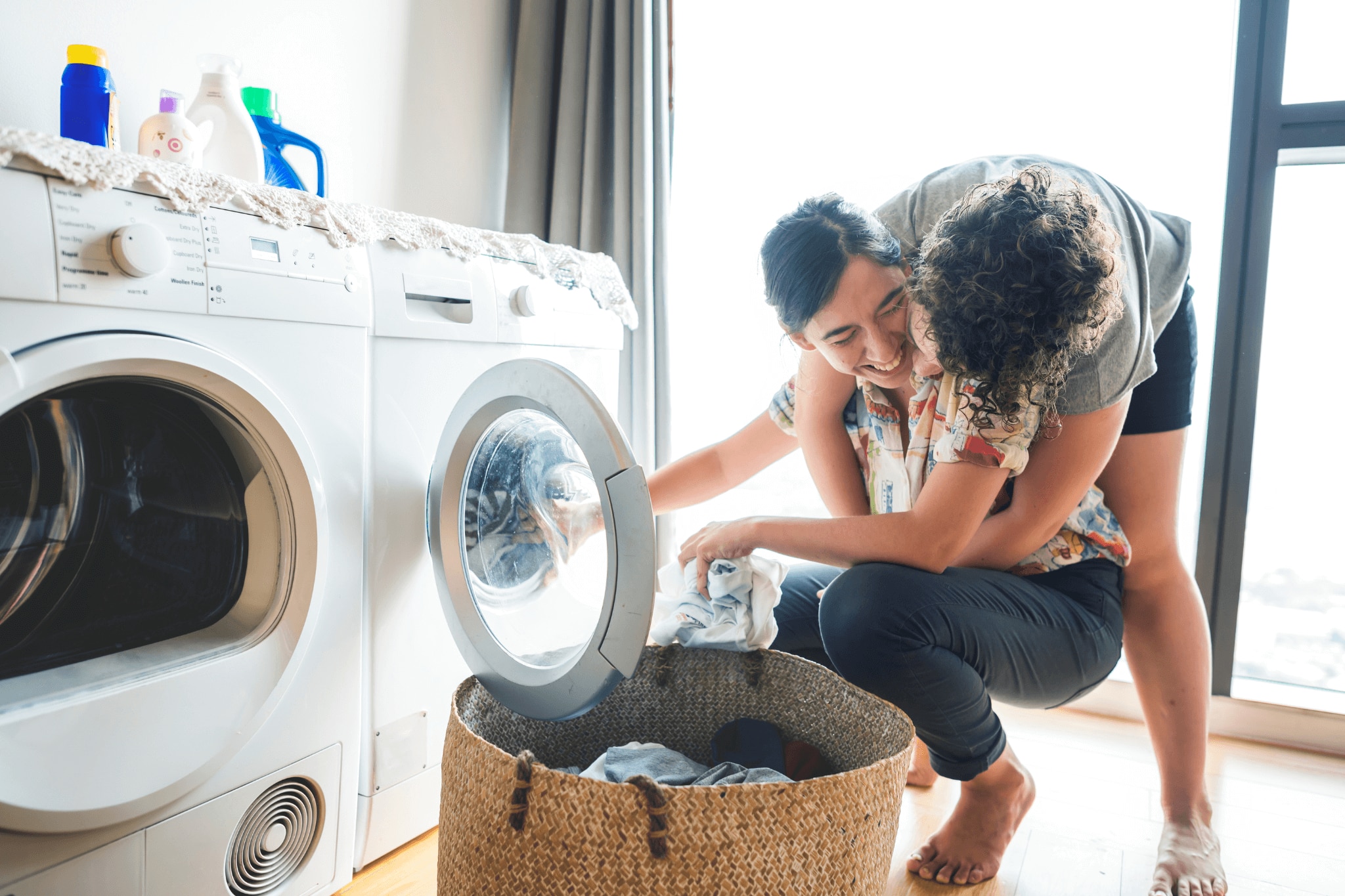 Couple doing laundry together after getting sweat smell out of clothes 