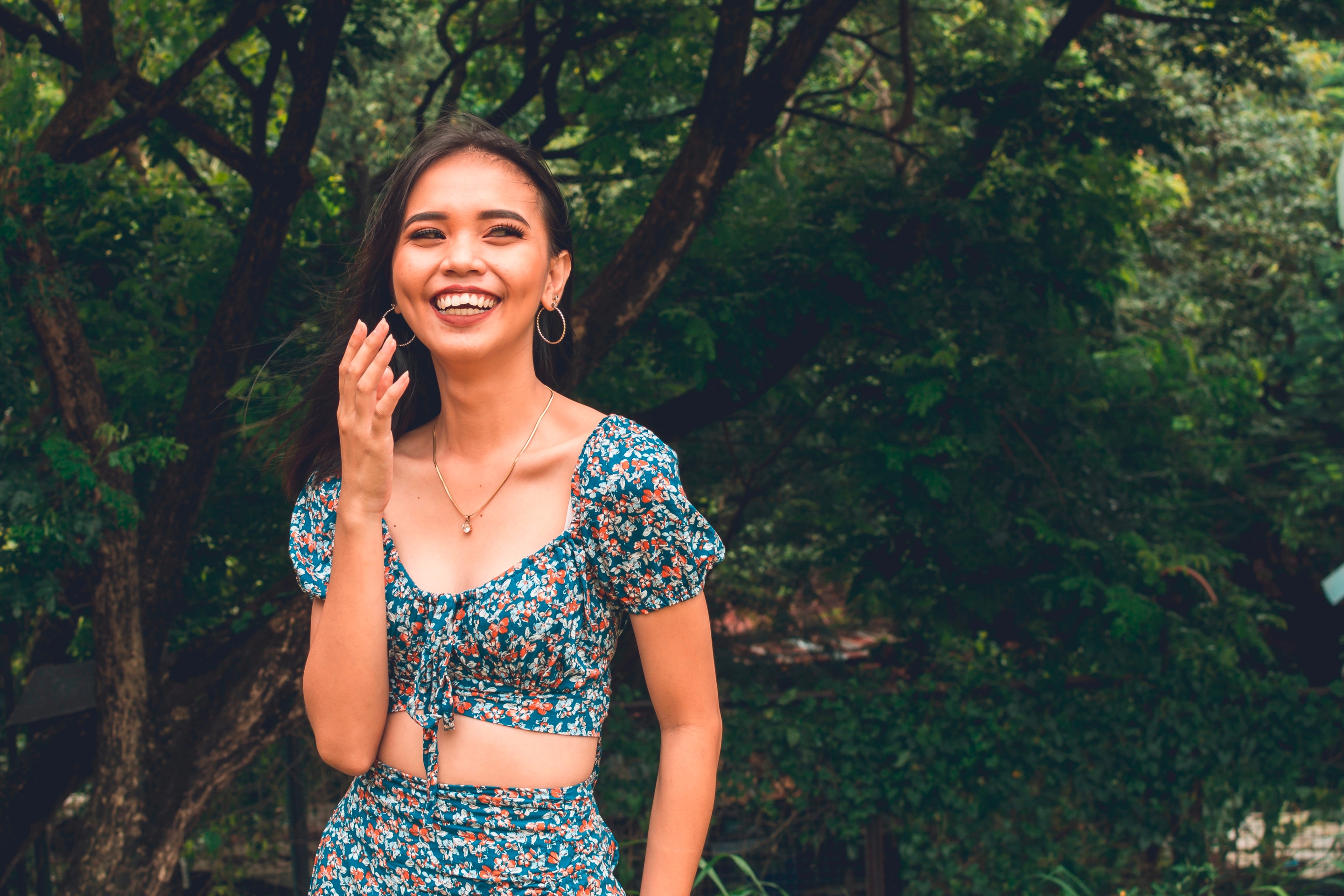 A Filipina with a round face happily spends a day at the park.