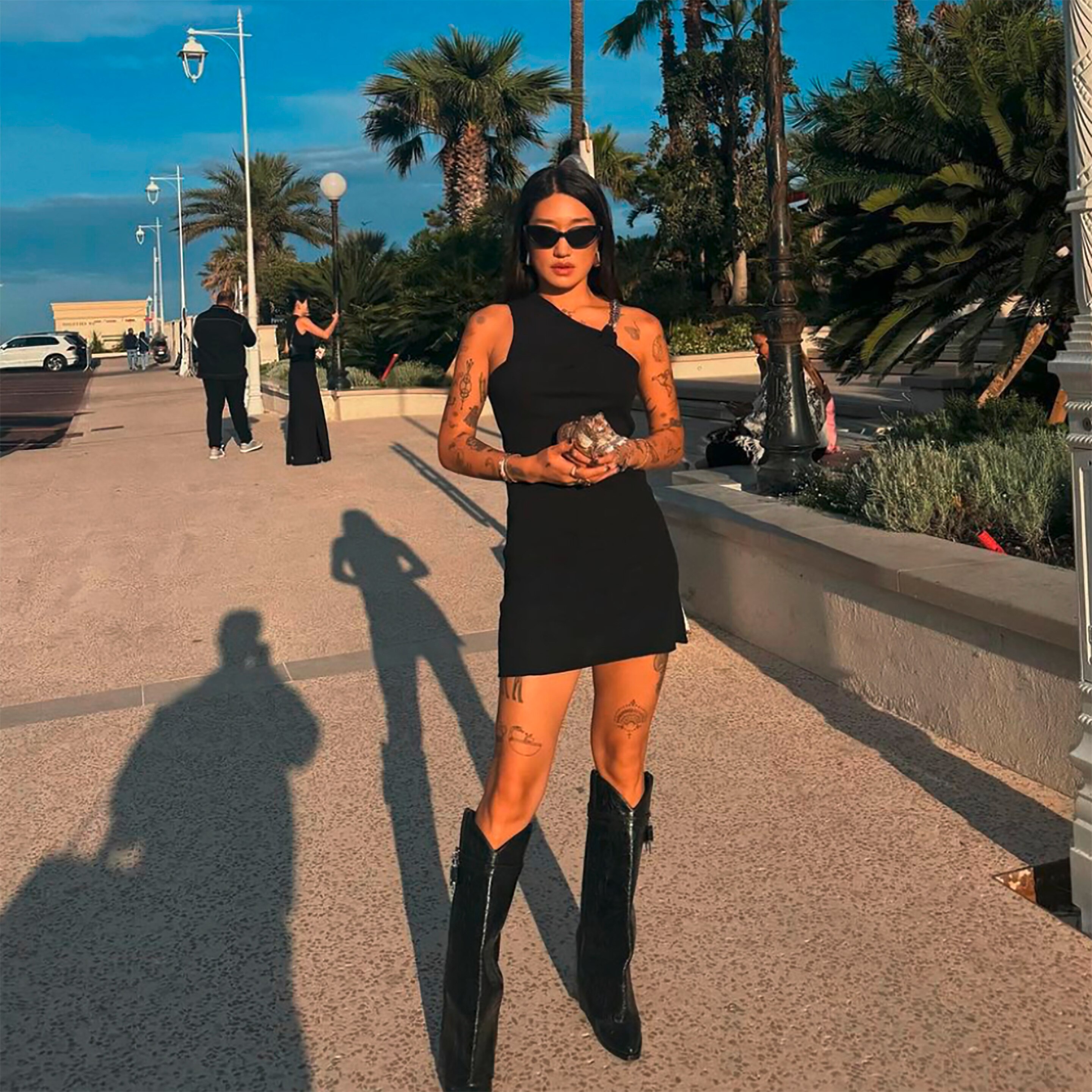 Peggy Gou in black dress and black boots.