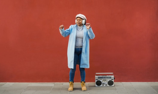 Older African American woman dancing with no sign of menopause sweating