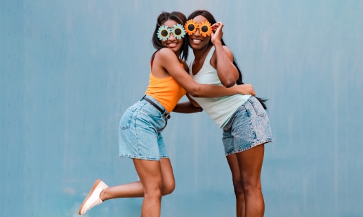 Female friends having fun outside on a hot summer day with no sign of underbreast sweat
