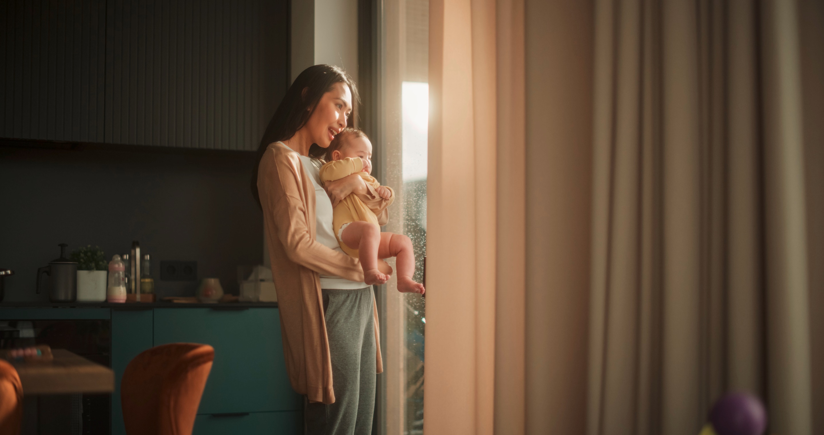 Mom with baby looking out the window.