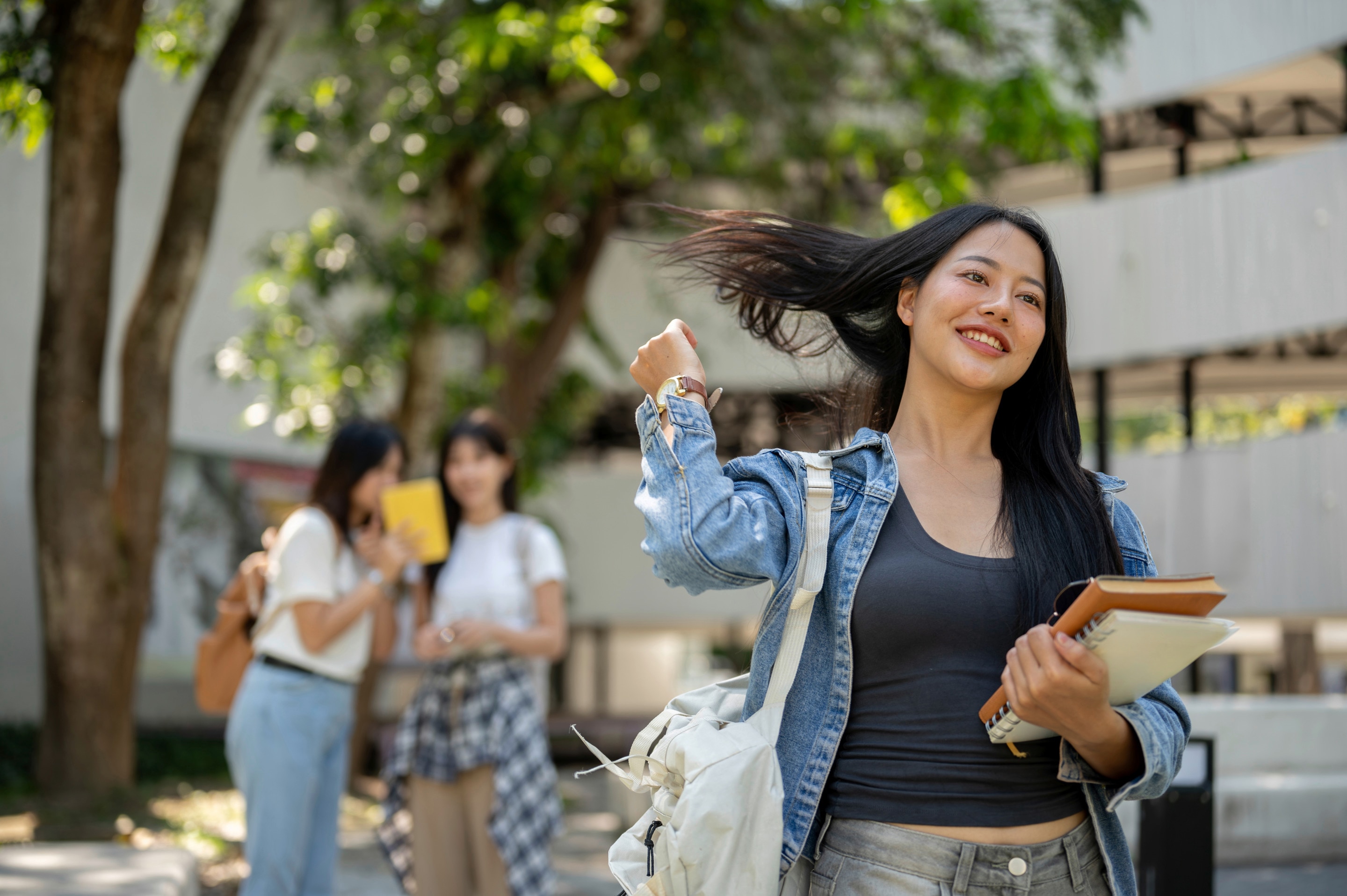 Student flipping her hair with one hand.
