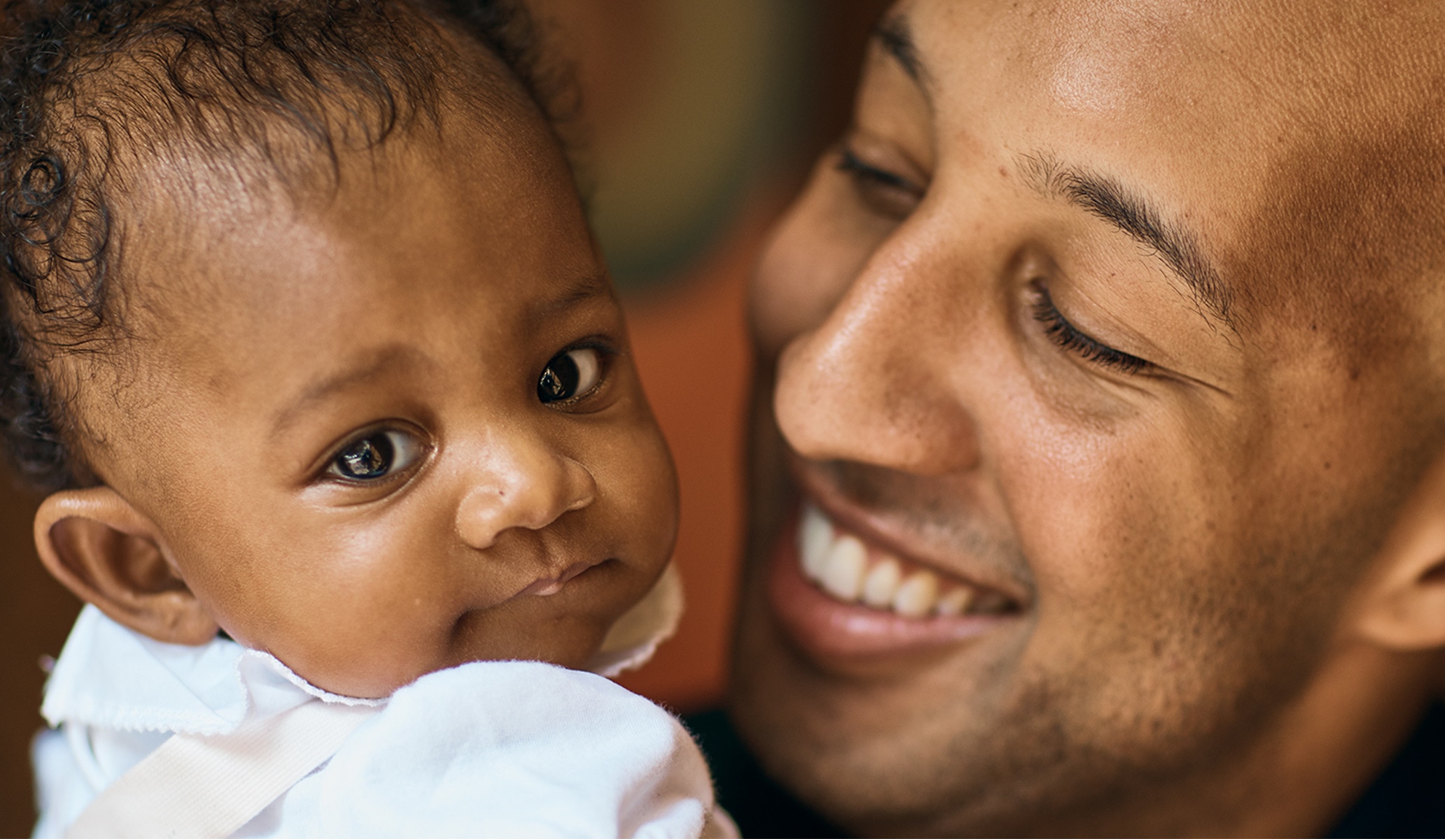 Smiling dad and his young baby