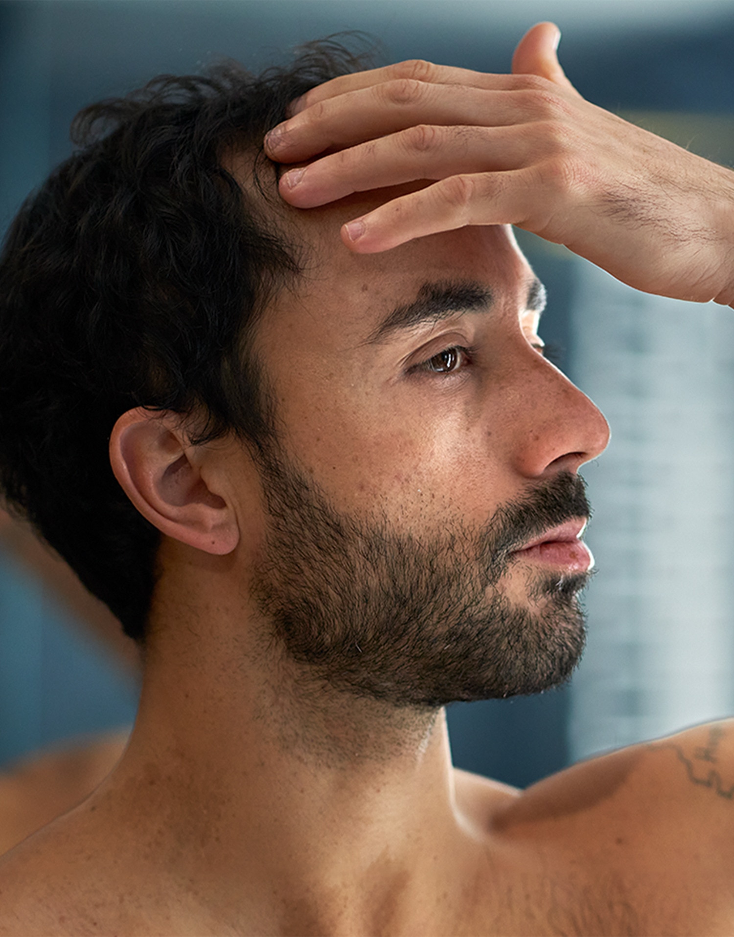 Man hand-combing his hair