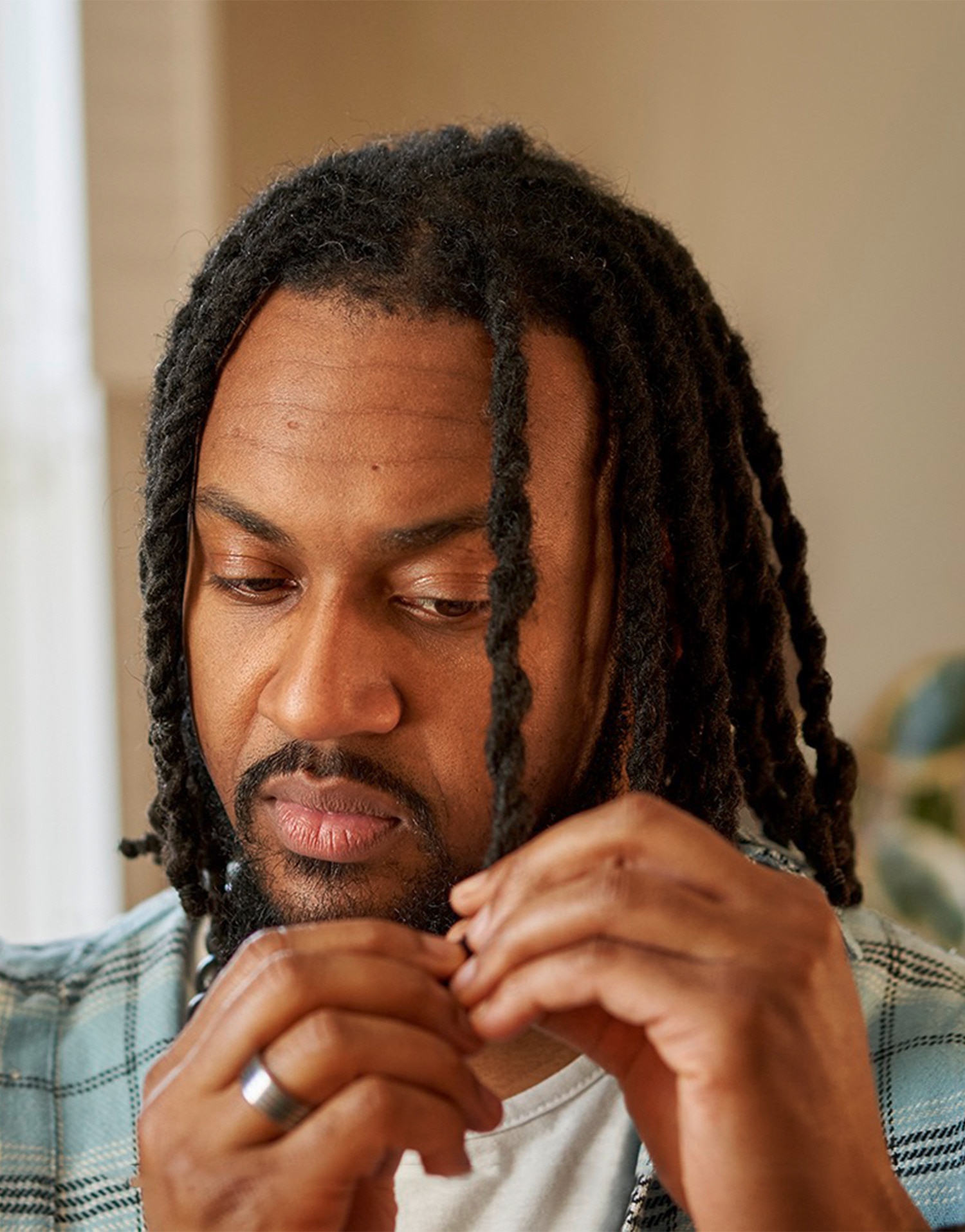 Man braiding his hair