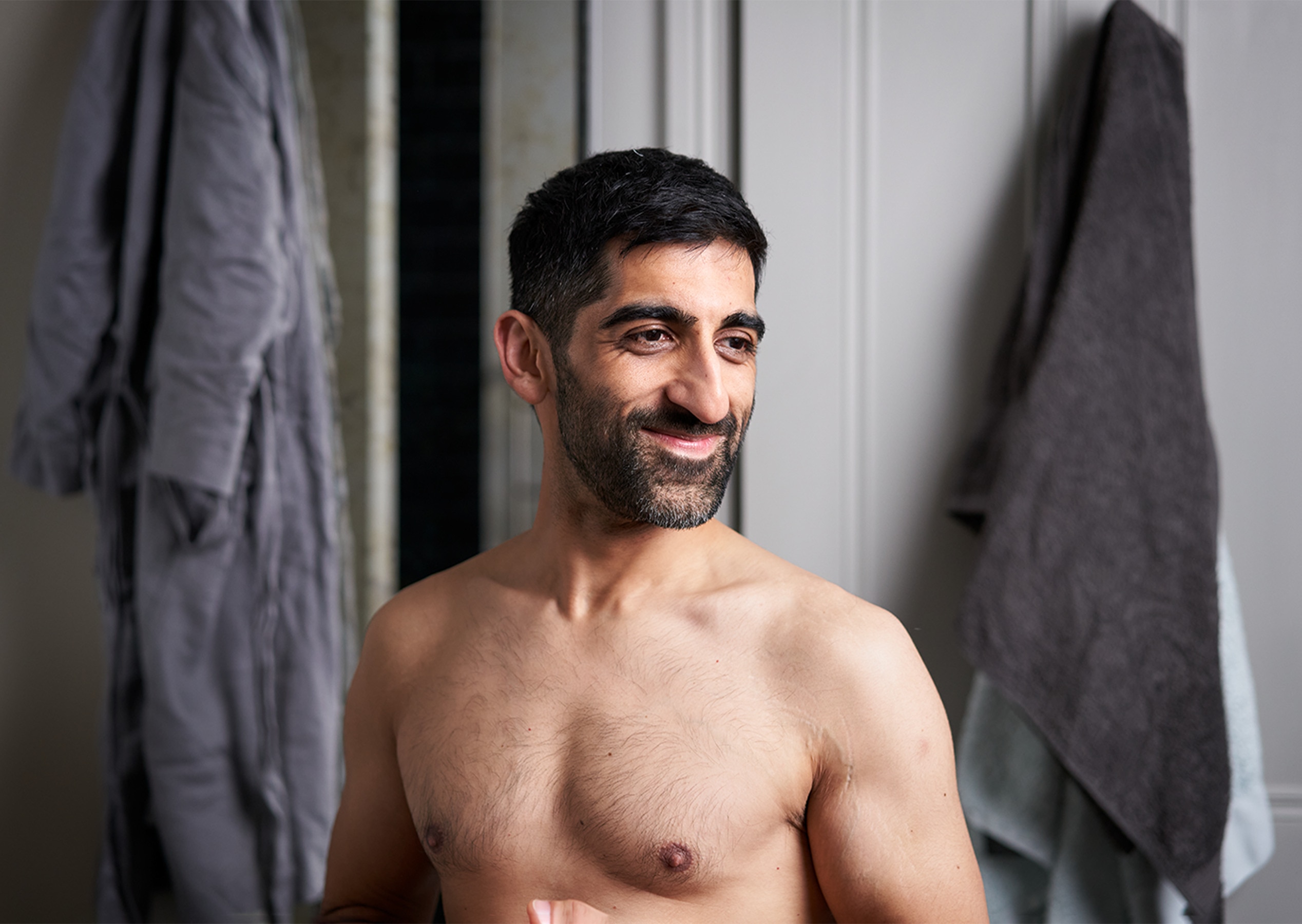 Man smiling in a bathroom