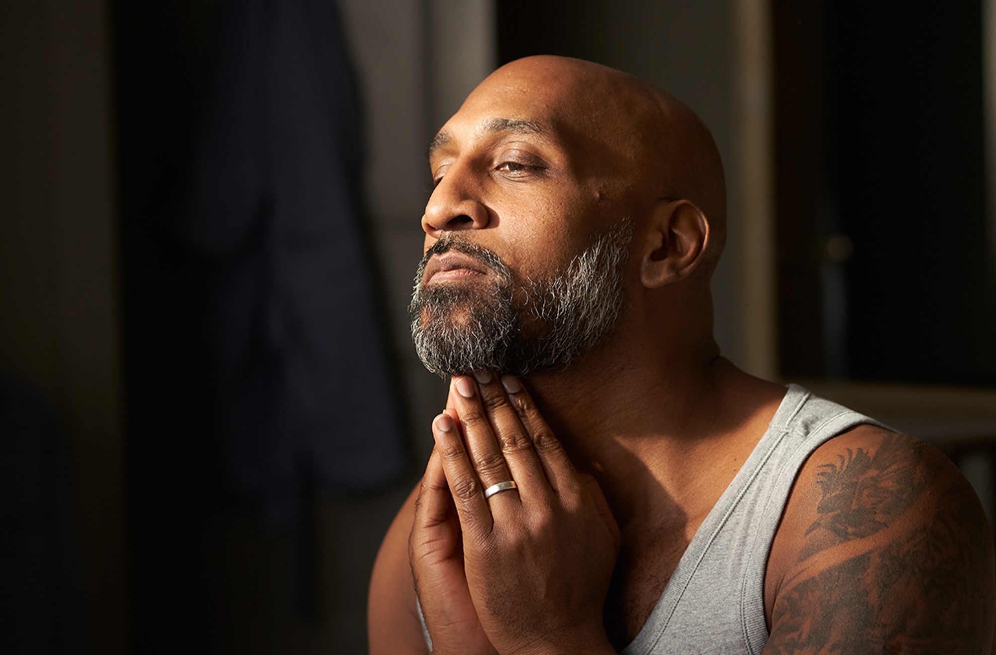 Man touching his beard with both hands