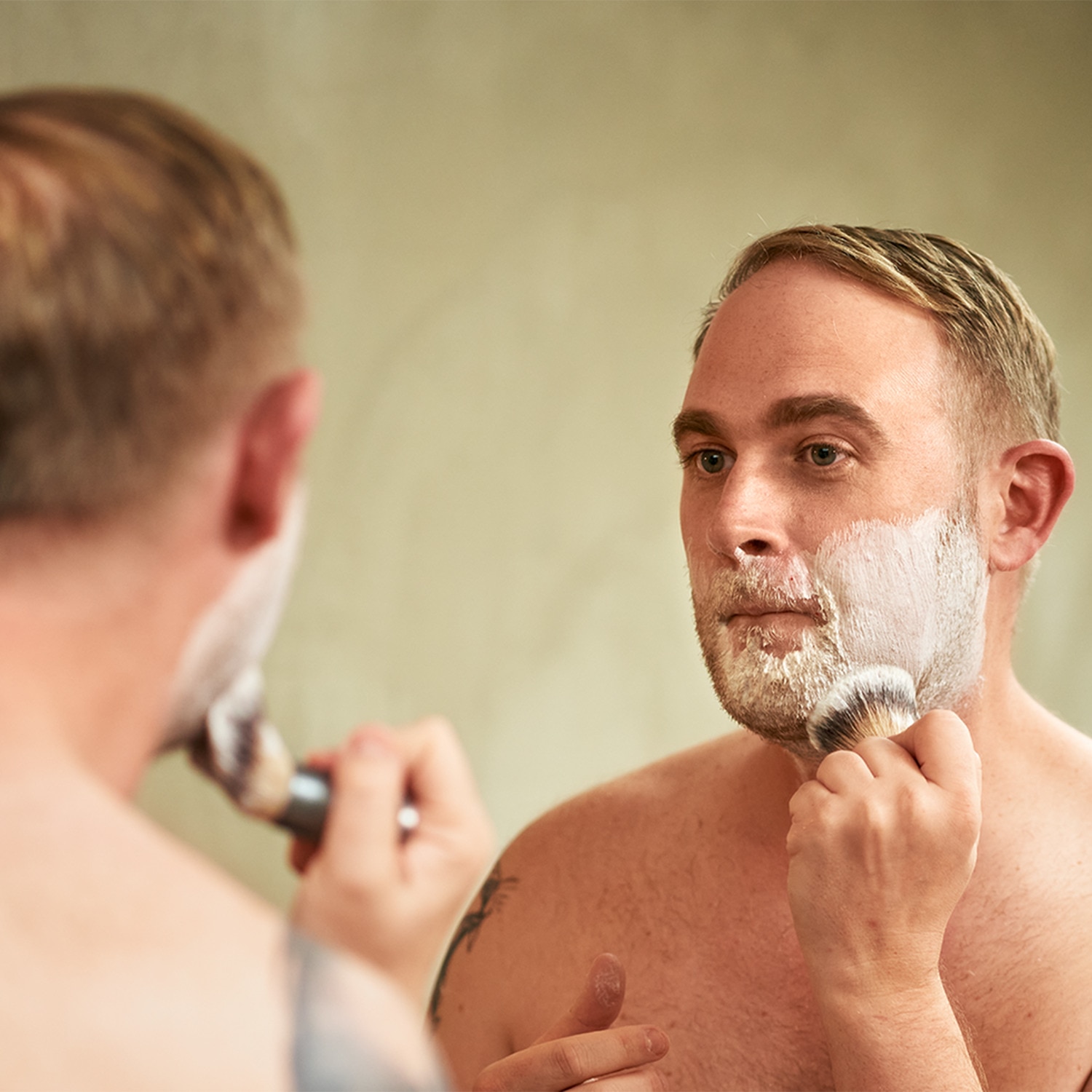 Man applying shaving foam with a shaving brush.