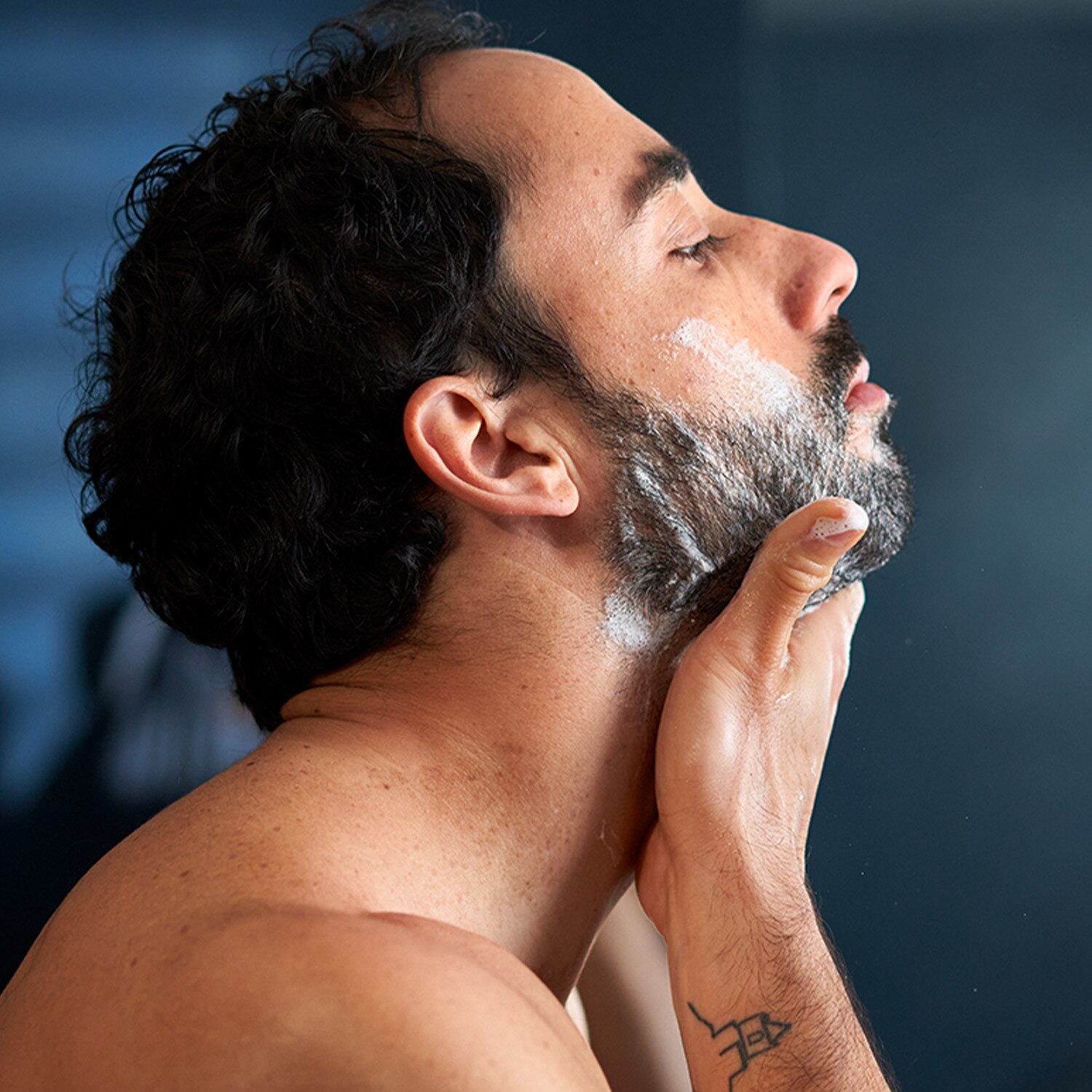 Man washing his beard
