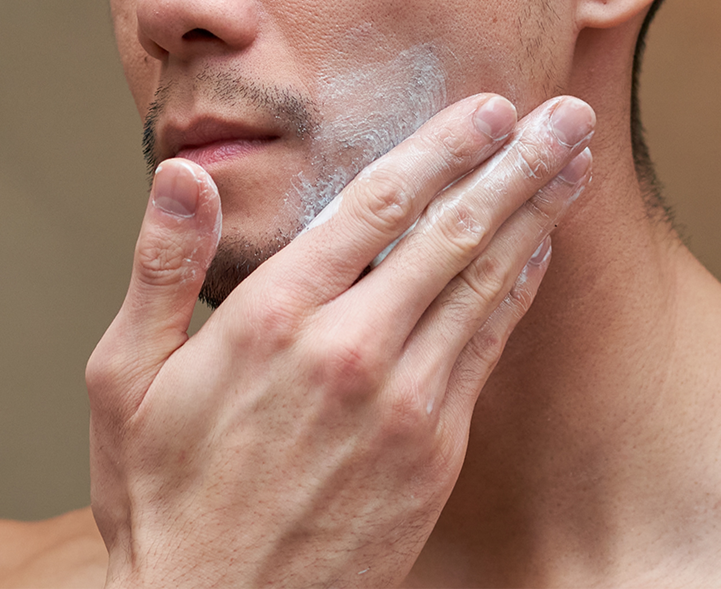Man rubbing product into his beard