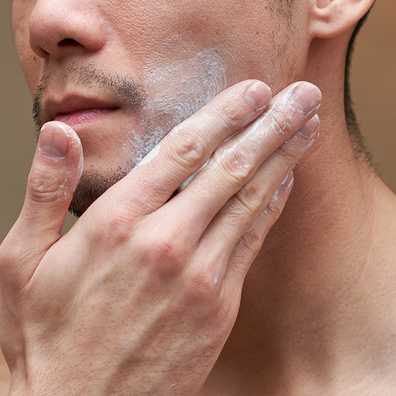Man applying cream to his beard