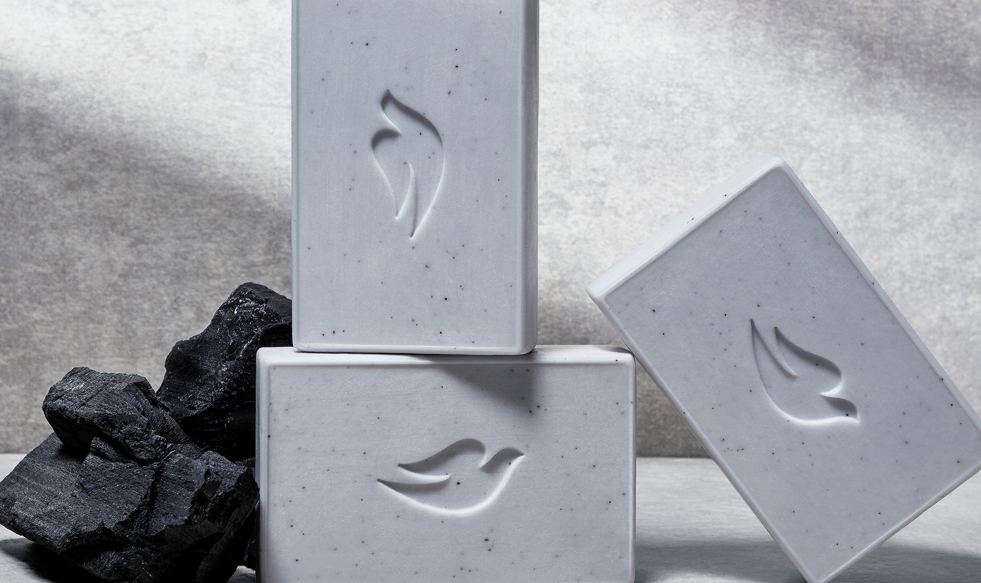Stack of gray Dove Men+Care cleansing bars in a bathroom