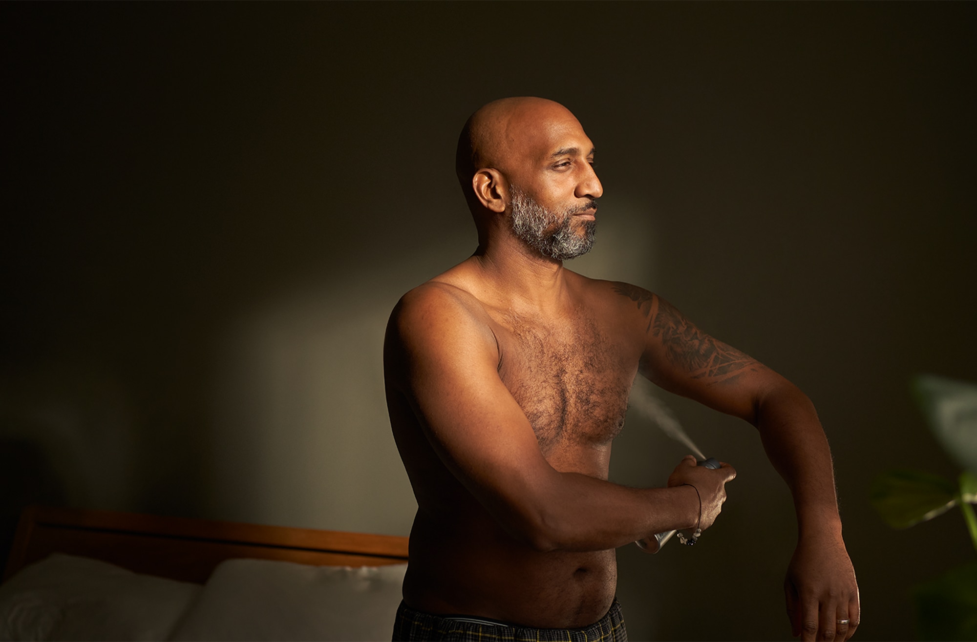 Man applying deodorant spray