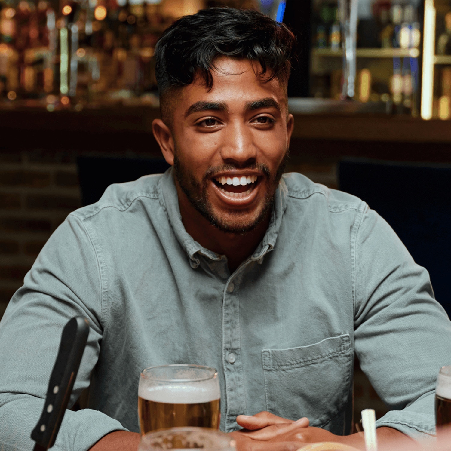 Man laughing at a bar