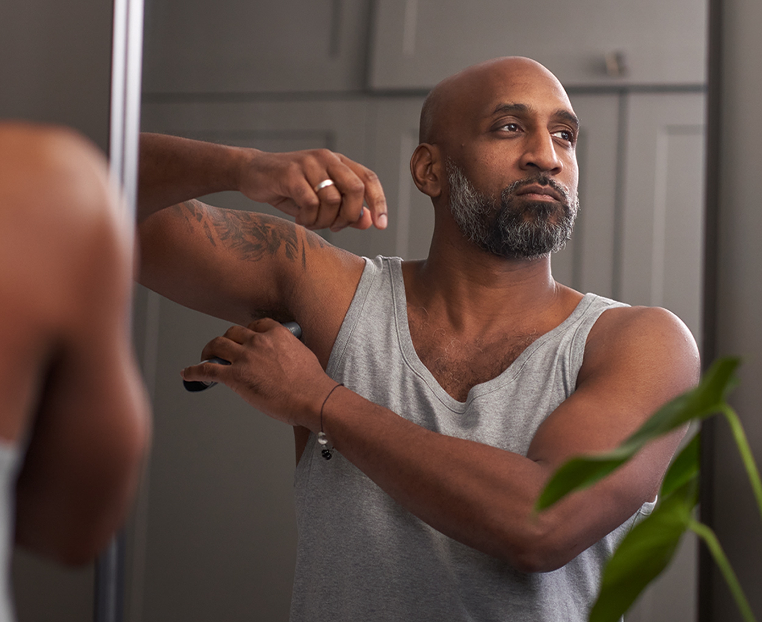 Man applying Dove Men+Care deodorant stick to his underarm