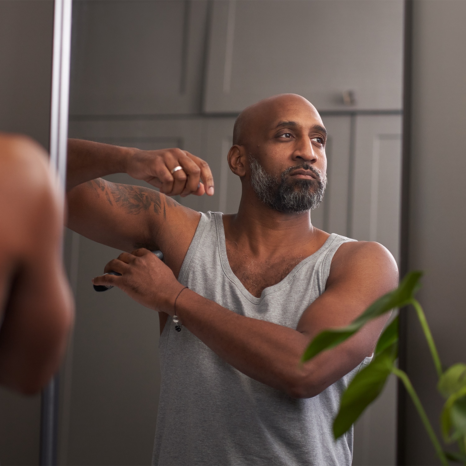 Man applying a deodorant stick to his underarm