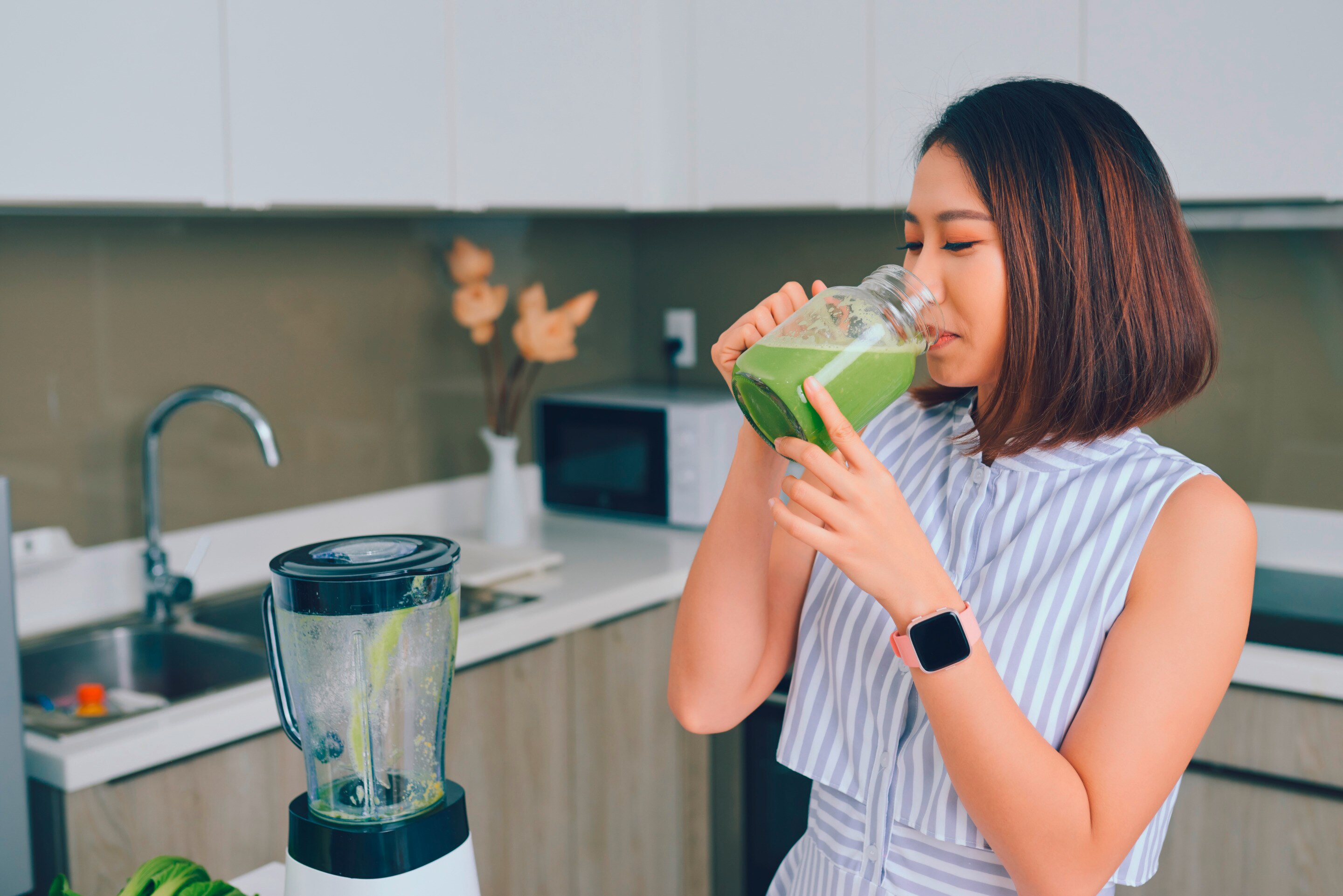 Woman drinking smoothie.