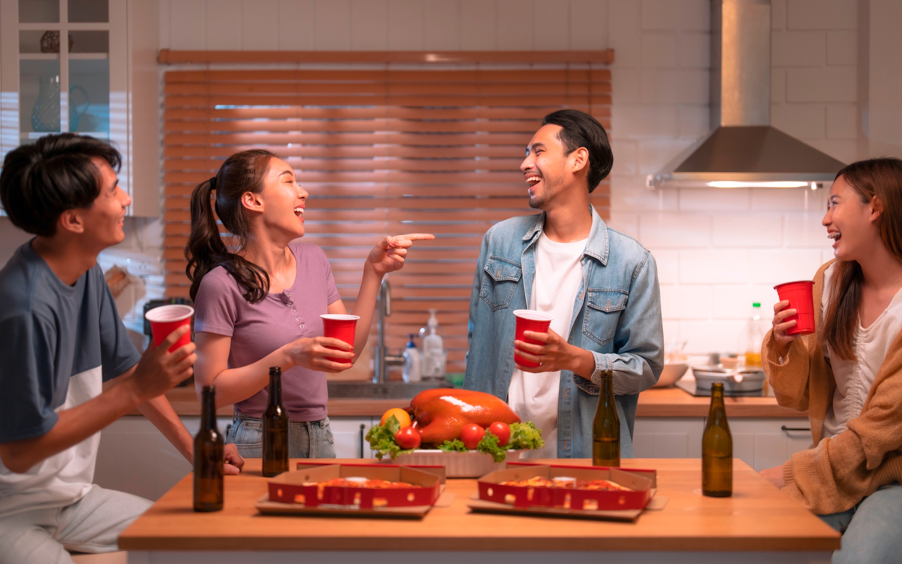 Group of male and female friends enjoying a home dinner.