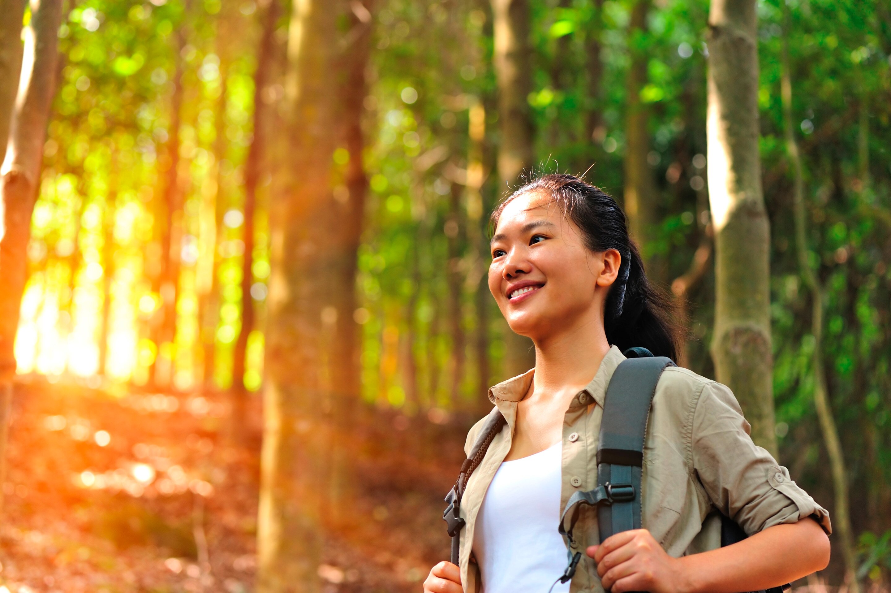 Asian woman hiking with backpack.