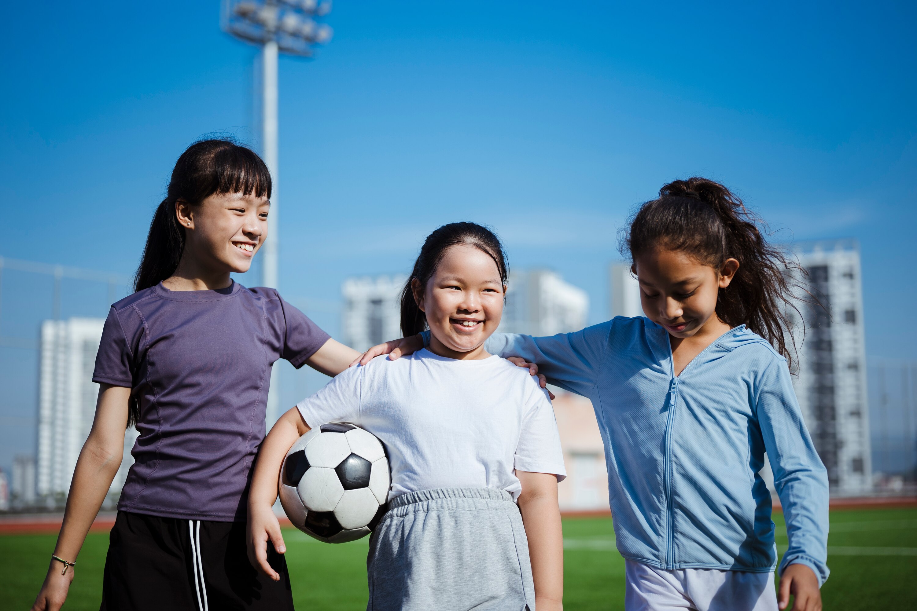 Three young girls with a football