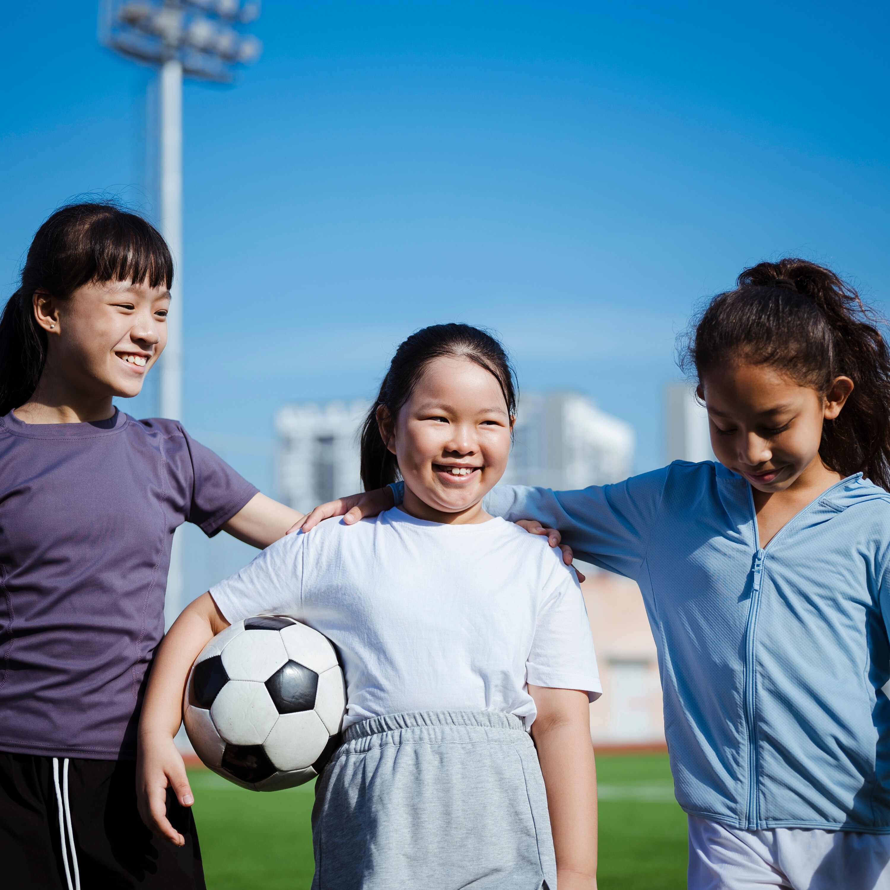 Three young girls with a football