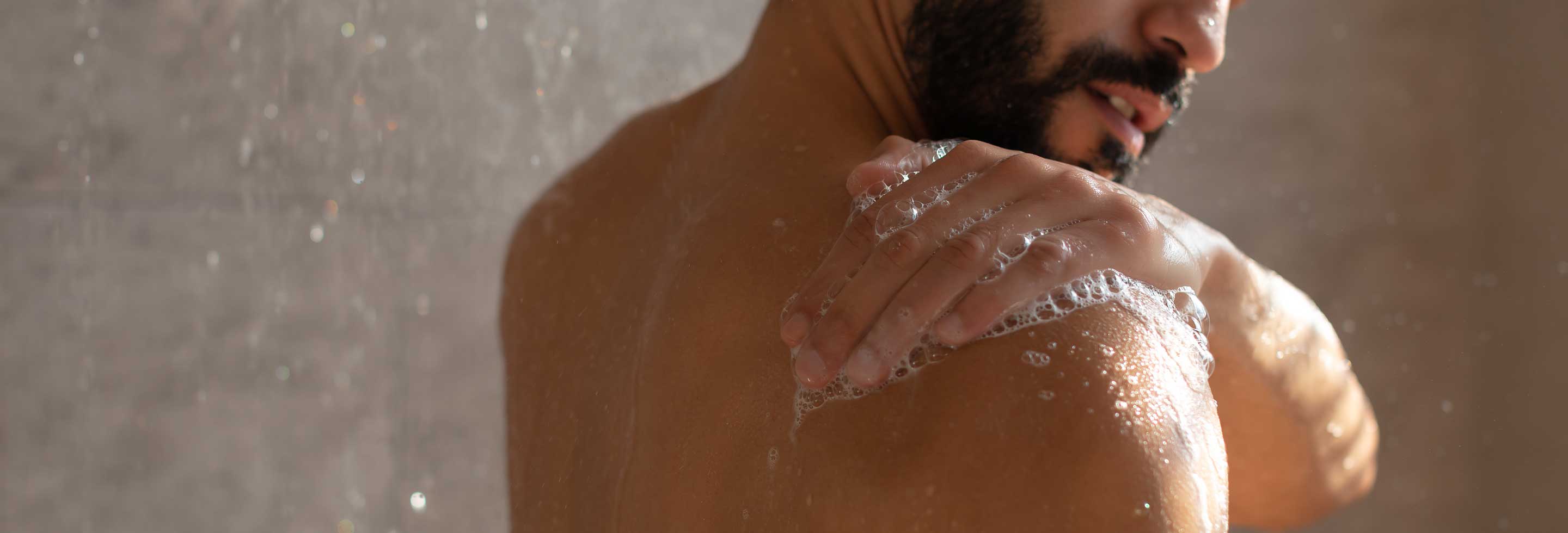 Young man in the shower with no sign of back acne