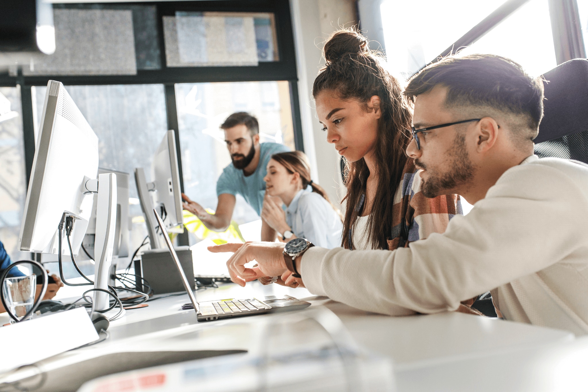 Office workers working closely together, some experience nose blindness 
