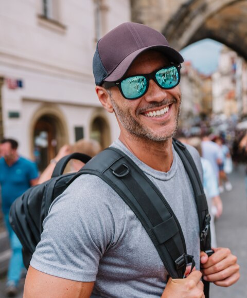 Man touring with a backpack with both straps on each arm 