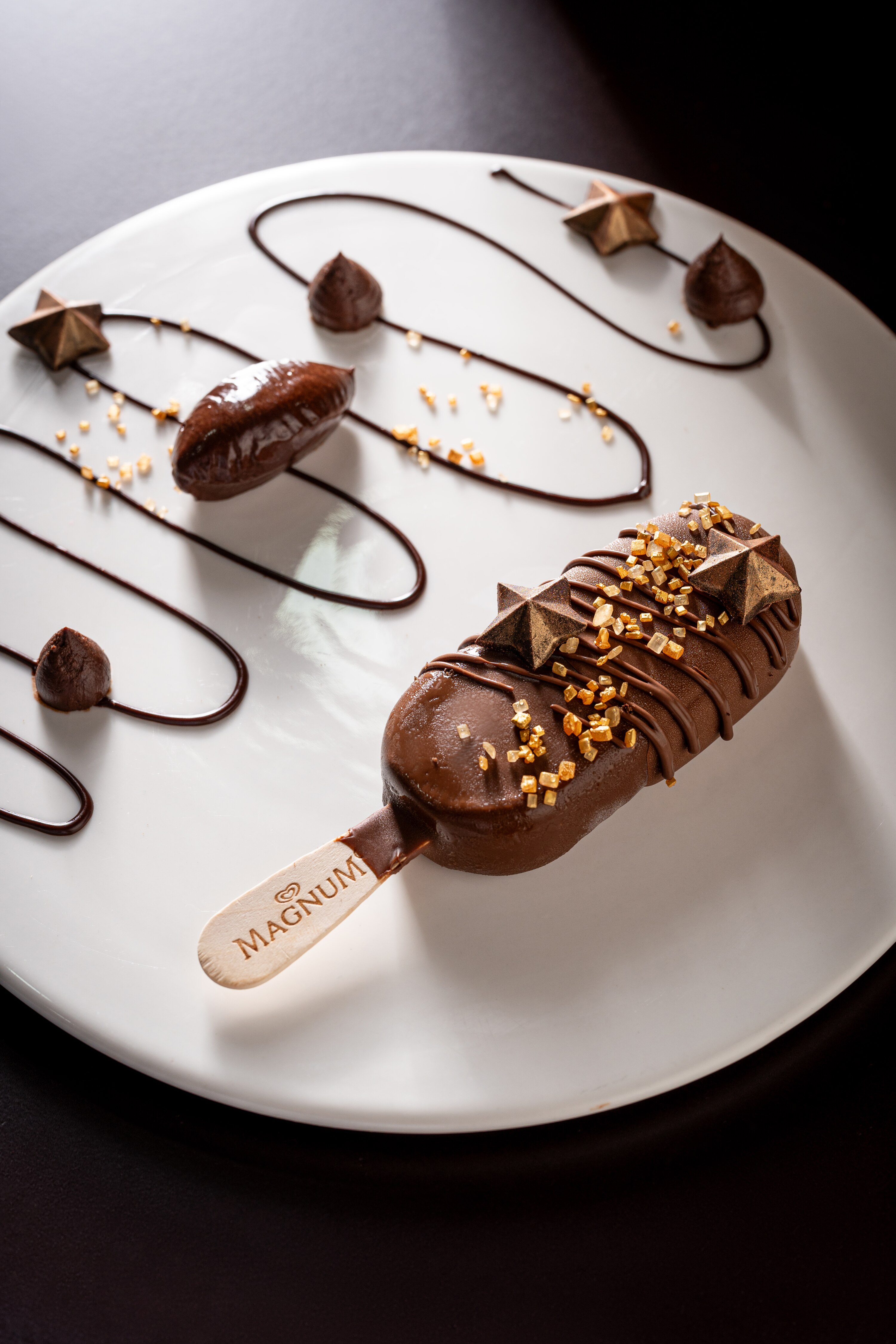 Magnum ice cream gold oval logo with brown "M" and brand name