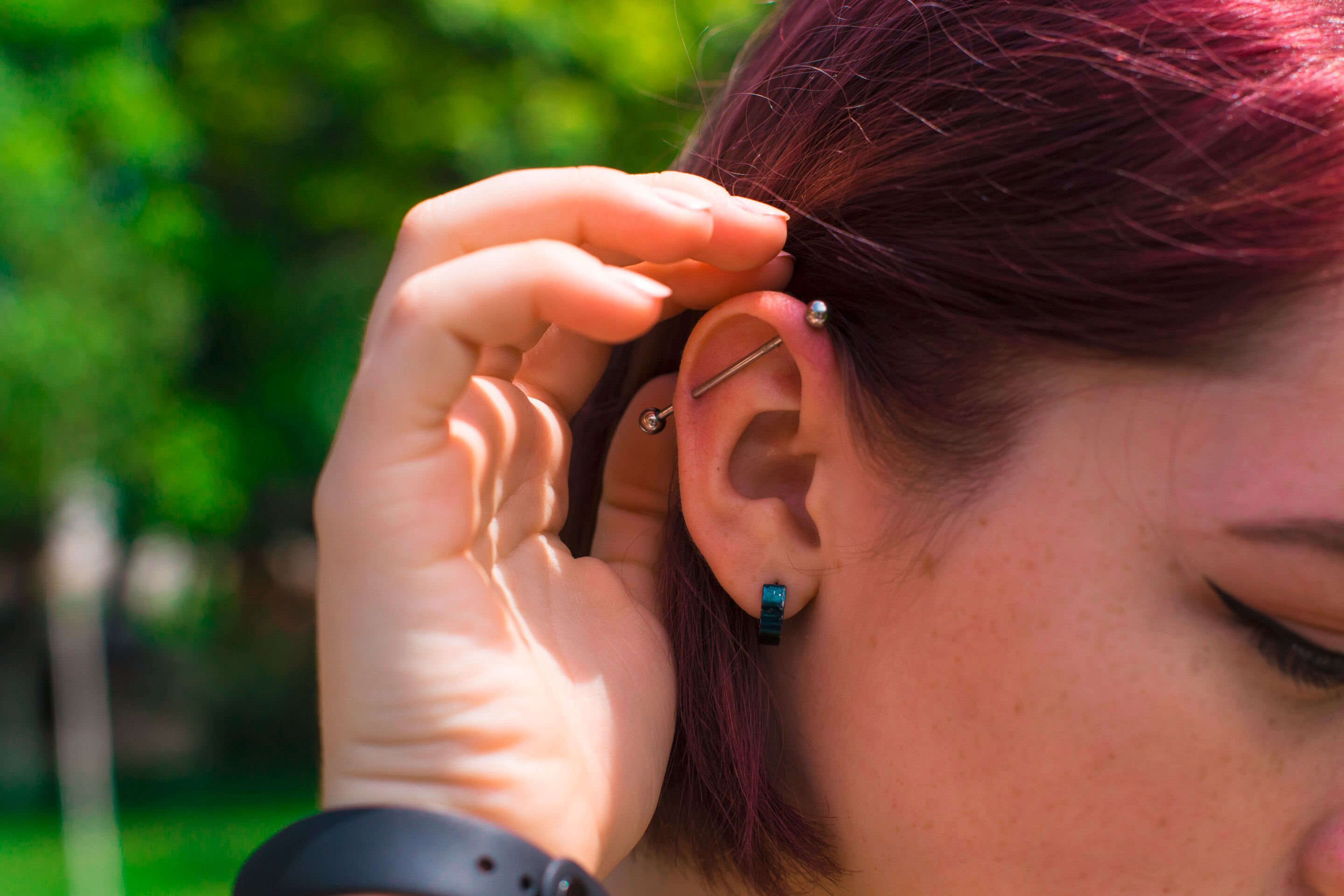 Woman with multiple ear piercings.