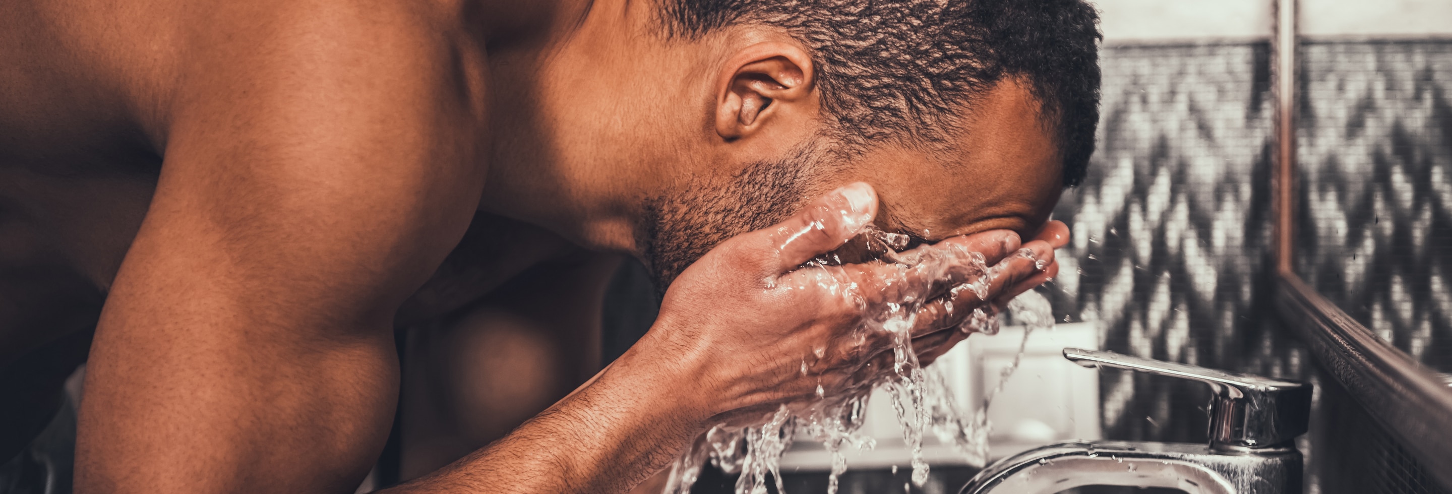 Man washing his face with a cleanser that contains stearic acid