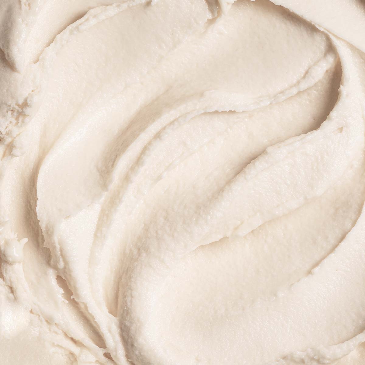 Close-up view of smooth, creamy ice cream with a soft, velvety texture